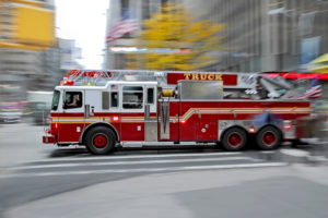 fire truck driving through a city