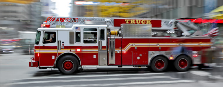 fire truck driving through a city