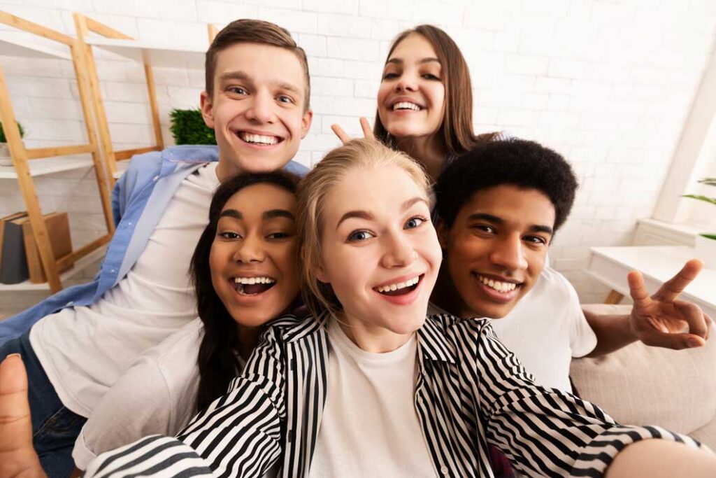 a group of teens looking into the camera and smiling