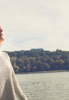 Woman breathing calmly in front of a lake