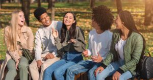 teens smiling and talking in a group