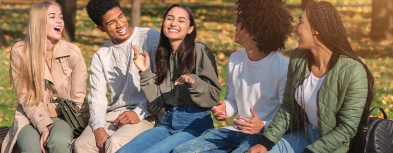 teens smiling and talking in a group