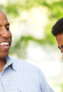 A father putting his hand on his son's shoulder