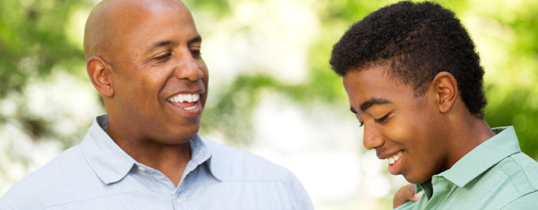 A father putting his hand on his son's shoulder