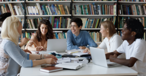 PHD students chatting in a library