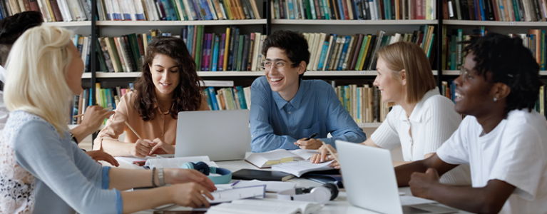 PHD students chatting in a library