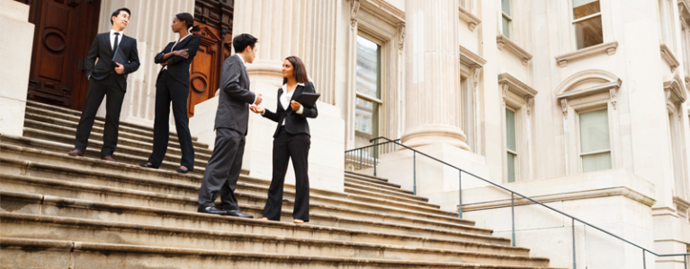 policy makers on the steps of a courthouse