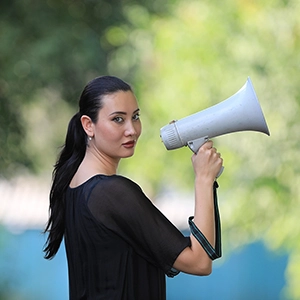 young woman holding a bullhorn