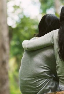 Girl hugging boy outside