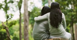 Girl hugging boy outside