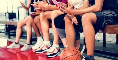 boys basketball team texting from the bench