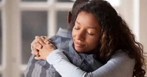 man and woman hugging warmly