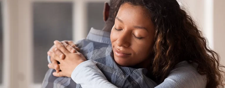 man and woman hugging warmly