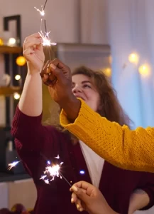 family and friends light sparklers together