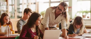 teacher works with students in a classroom