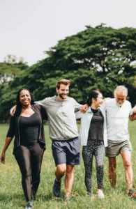 group of people walking outside with their arms linked