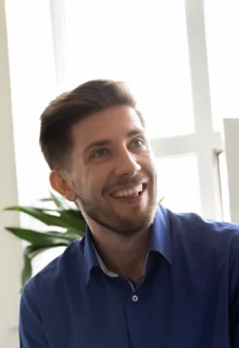 three smiling people look at a presenter