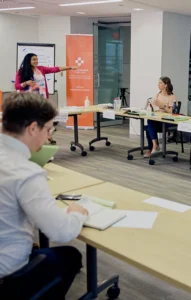 an instructor leads a mental health first aid course in a conference room