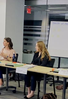 an instructor leads a mental health first aid course in a conference room