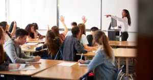 teacher calls on students with their hands raised