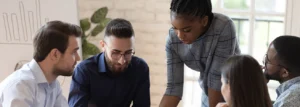 colleagues work together around a conference table