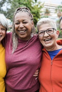smiling women stand together arm in arm