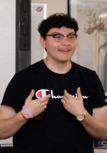 a young man speaks in a classroom