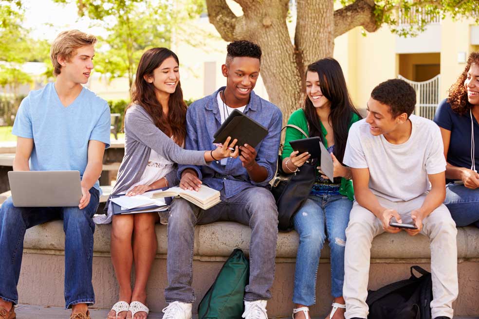 a group of students looking together outside