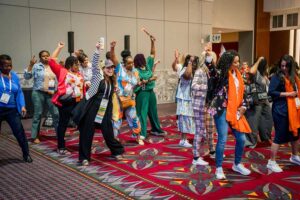 a group of people dancing at a conference