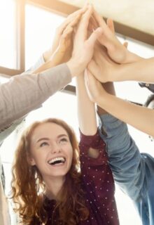 people celebrating with their hands in the middle of a circle