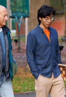 an older man and a younger man walk together